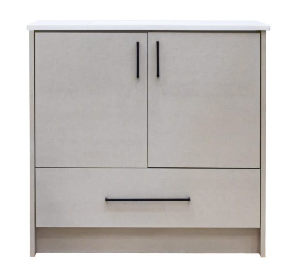 Beige light wood bathroom vanity cabinet with white marble countertop, two cabinet doors with black handles, and one drawer below