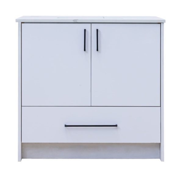 Contemporary white bathroom vanity cabinet with gray marble top, two upper doors with black handles, and one lower drawer