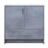 Light gray concrete-textured bathroom vanity cabinet with white marble countertop, two cabinet doors with metallic handles, and one drawer below
