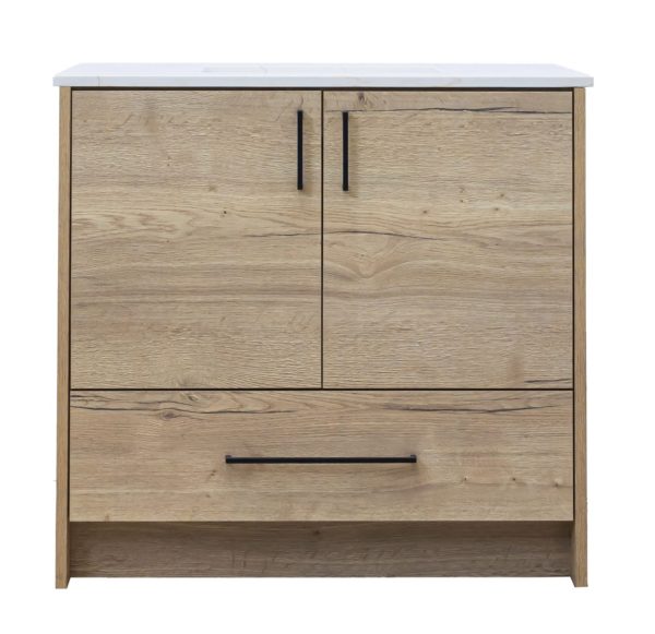 Light natural wood bathroom vanity cabinet with white marble countertop, two cabinet doors with black handles, and one drawer below