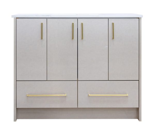 Light gray linen textured bathroom vanity with four upper cabinet doors and two lower drawers, featuring brass/gold handles and a white countertop with integrated sink