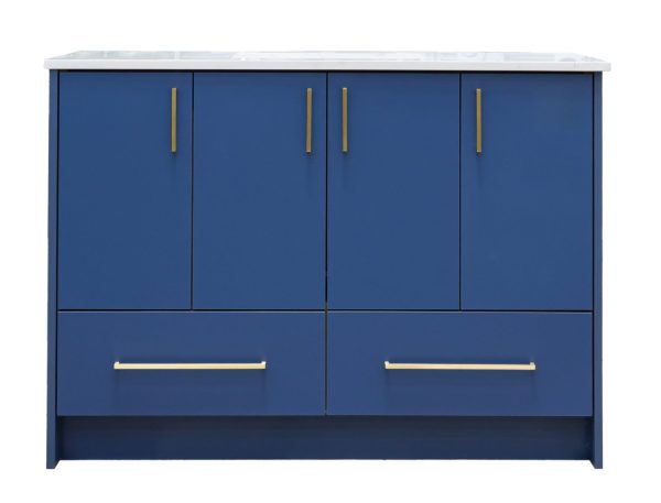 Navy blue bathroom vanity cabinet with four upper doors with gold handles and two lower drawers with gold pulls, topped with white marble countertop