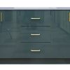 Dark teal green vanity cabinet with dual sinks, three center drawers with brass handles, and two side cabinet doors with brass pulls