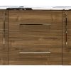 Natural wood vanity with white countertop, chrome handles, two center drawers and side cabinet doors with chrome vertical pulls