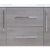 Gray textured bathroom vanity with white countertop, two cabinet doors with silver vertical handles, and two center drawers with metallic handles