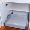 White kitchen cabinet with pull-out drawers open showing empty gray interior storage