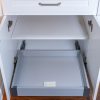 Open kitchen cabinet showing two fully extended pull-out drawers with soft-close hardware and internal mounting brackets