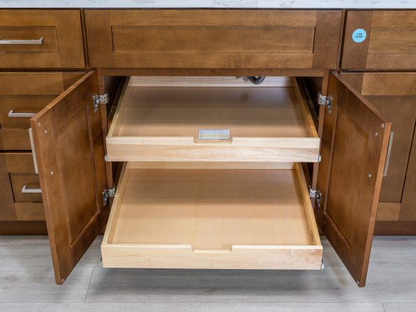 Wooden kitchen cabinet with both pull-out drawers fully extended and open, displaying full-depth storage organization