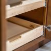 Close-up detail of wooden pull-out drawer slides showing natural wood construction with curved handles and metal bracket hardware in kitchen cabinet
