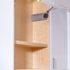 Open kitchen cabinet door revealing wooden shelves with a paper towel holder mounted inside