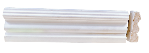 White painted baseboard molding with ornamental curved design and exposed wood end
