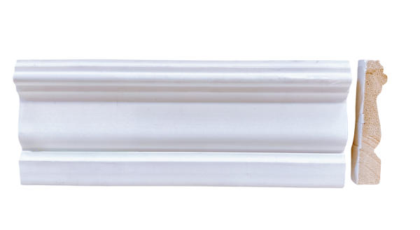 White painted decorative baseboard molding with curved profile and wooden end grain visible