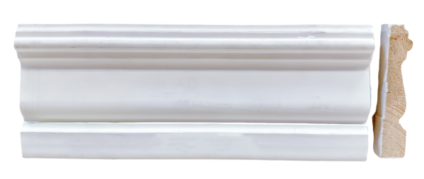 White primed baseboard trim with curved crown molding detail and decorative wooden edge