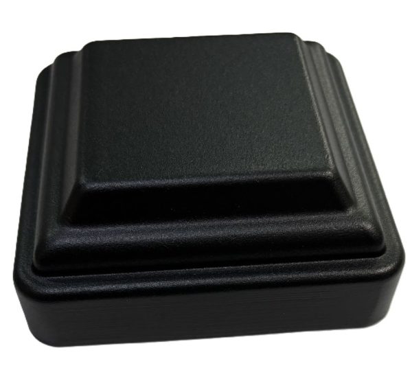 Black plastic post cap with stepped pyramid design for fence posts or deck railings