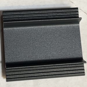 Black metal rectangular plate with horizontal ribbed or finned pattern