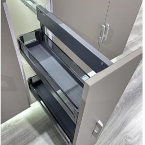 Open kitchen cabinet with pull-out drawer organizers showing two gray mesh storage trays
