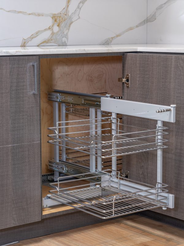 Kitchen corner cabinet with three-tier pull-out wire basket organizer system extended open showing chrome shelving and storage capacity