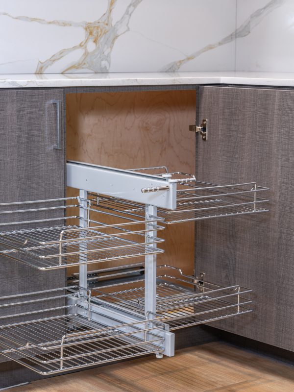 Kitchen corner cabinet with pull-out wire basket organizer showing extended two-tier chrome shelving system partially pulled out