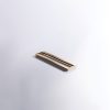 Gold and black metal flush-mount handle with sleek modern style on white surface