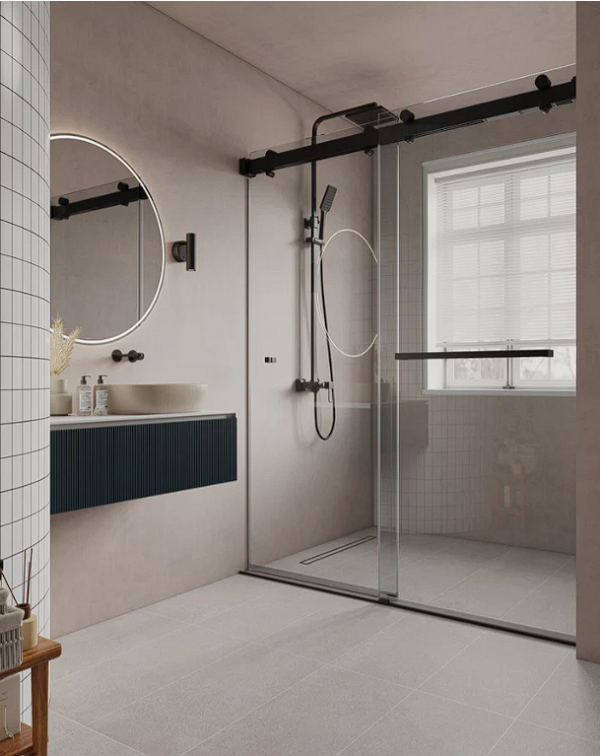 Modern bathroom with black framed glass shower enclosure, white tile walls, circular illuminated mirror, dark blue vanity cabinet, and window with blinds