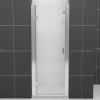 Frameless glass shower door with white subway tile enclosure and chrome hardware
