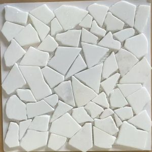 White ceramic mosaic tiles arranged in an irregular pattern on a white backing