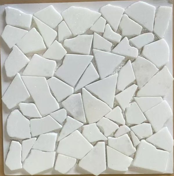 White ceramic mosaic tiles arranged in an irregular pattern on a white backing