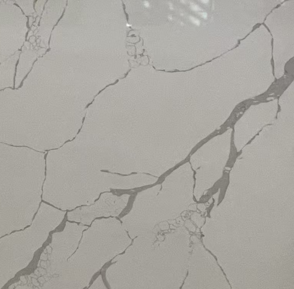 Gray marble surface with dark gray and charcoal branching veins and cracks