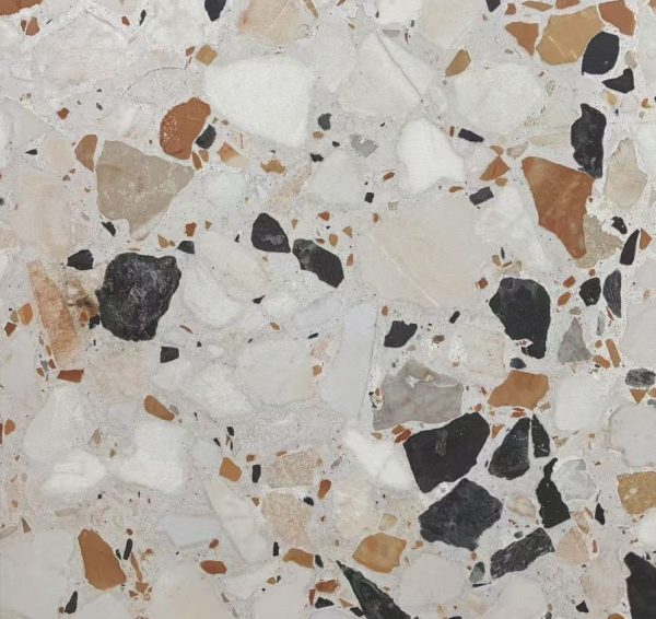 Terrazzo flooring with white base, black aggregate, tan and brown stone chips, and white marble flecks in polished finish
