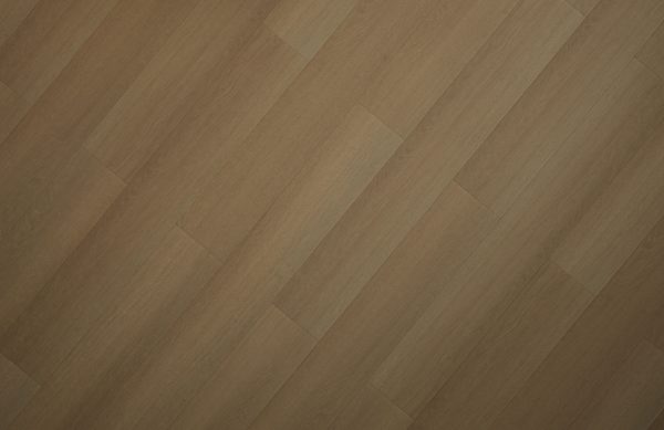 Close-up of herringbone pattern wood flooring in light tan and beige tones