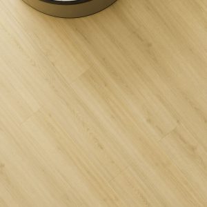 Light cream wood-look vinyl flooring installed in bathroom with white baseboard
