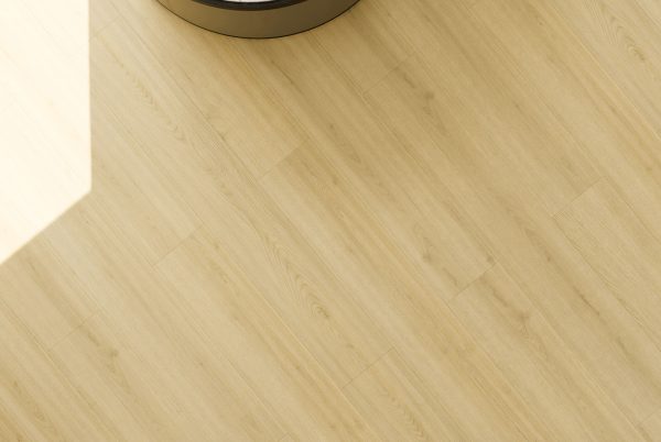 Light cream wood-look vinyl flooring installed in bathroom with white baseboard