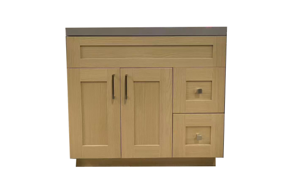 Natural wood vanity cabinet with two doors, center divider, and two right-side drawers with gray countertop