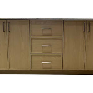 Natural wood vanity cabinet with five doors and three center drawers featuring metal handles